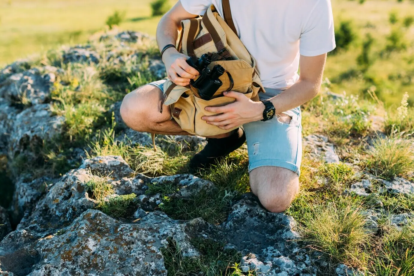 Nahaufnahme eines Wanderers, der ein Fernglas hält.